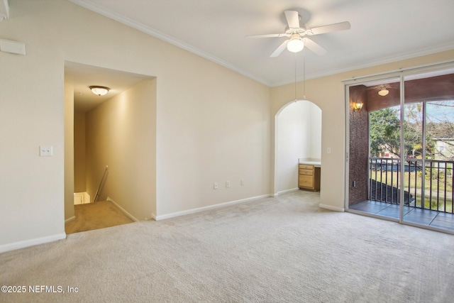 carpeted empty room featuring ceiling fan and crown molding