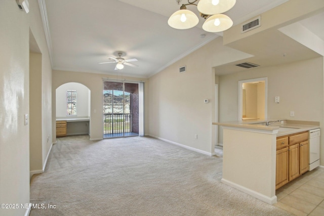 unfurnished living room featuring ornamental molding, light colored carpet, sink, and ceiling fan with notable chandelier