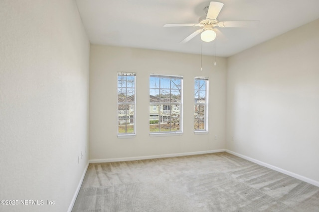 empty room featuring light carpet and ceiling fan