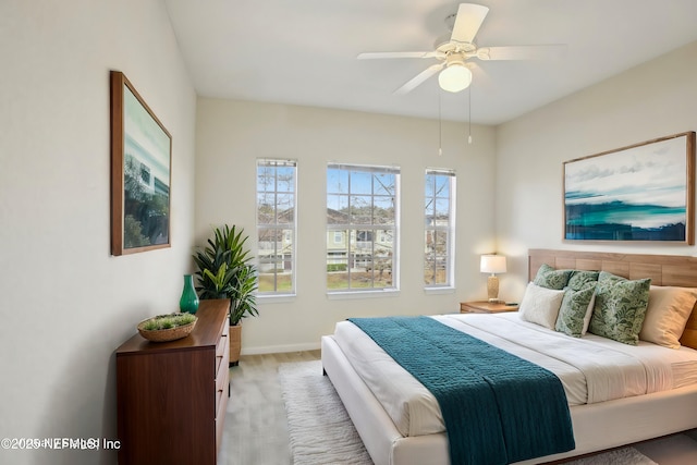 bedroom featuring ceiling fan and light hardwood / wood-style floors