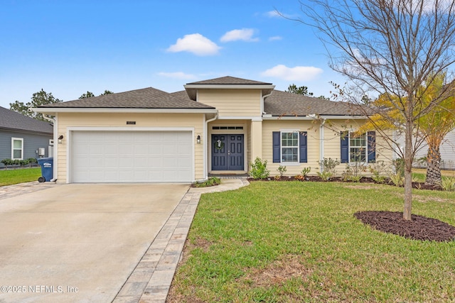 view of front of home with a front yard and a garage