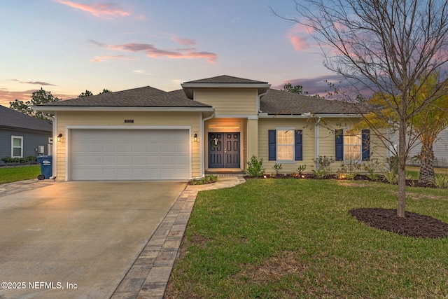 view of front of home with a yard and a garage