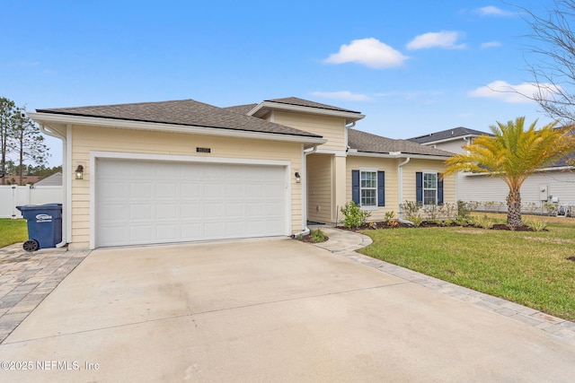 view of front of property featuring a front yard and a garage