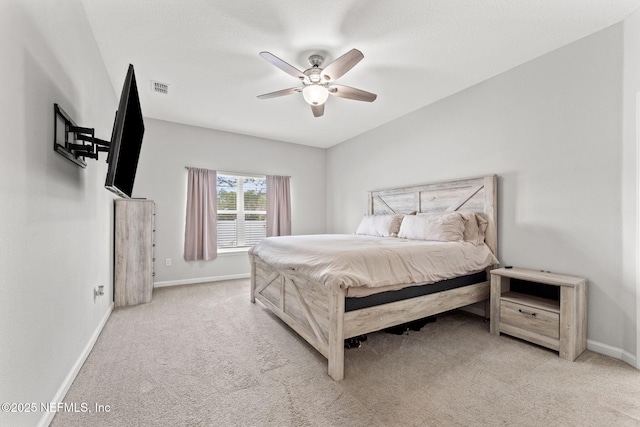 bedroom featuring light carpet and ceiling fan