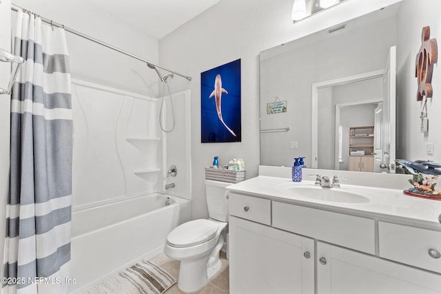 full bathroom with tile patterned flooring, shower / tub combo with curtain, vanity, and toilet