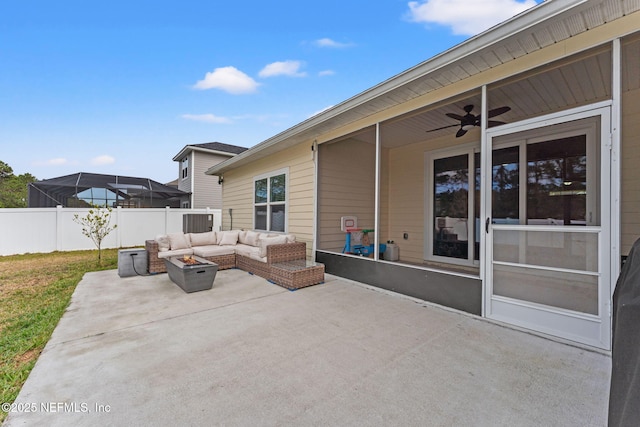 view of patio with ceiling fan and an outdoor living space with a fire pit