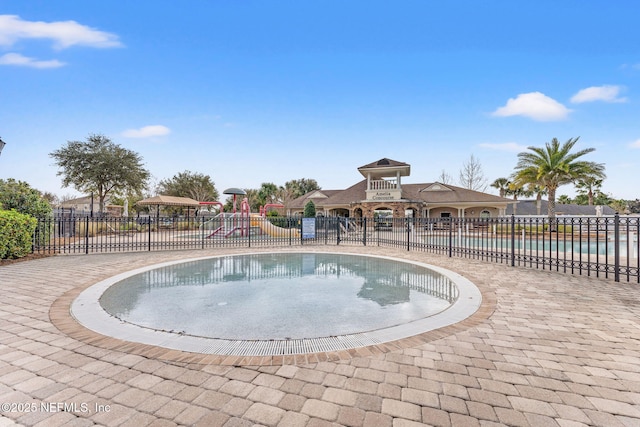 view of swimming pool featuring a playground