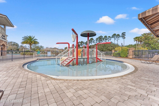 view of swimming pool featuring a playground