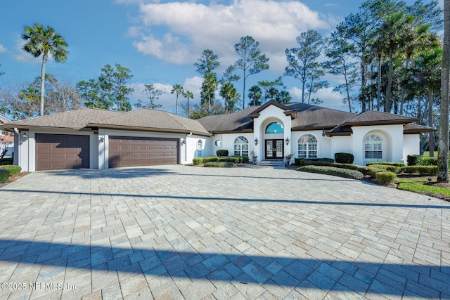 single story home with french doors and a garage