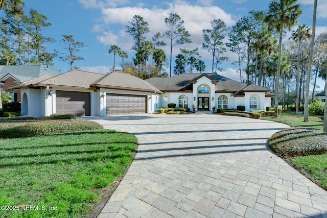 ranch-style house featuring a garage and a front yard