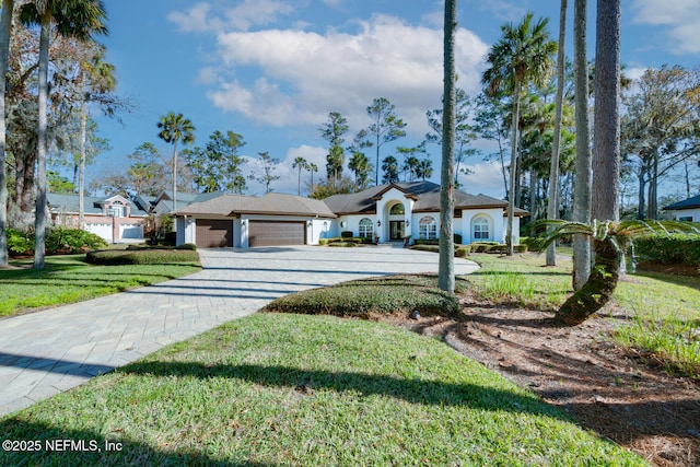 ranch-style house featuring a front lawn and a garage