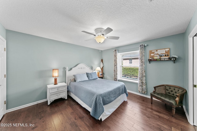 bedroom featuring ceiling fan, dark hardwood / wood-style flooring, and a textured ceiling