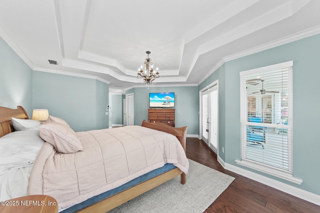 bedroom featuring dark hardwood / wood-style floors, a raised ceiling, a notable chandelier, and crown molding