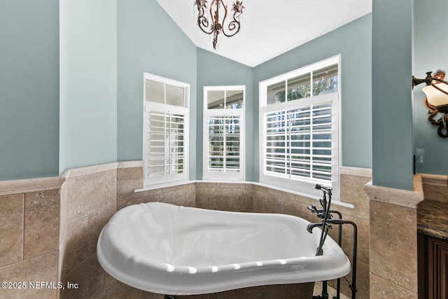 bathroom with a tub, tile walls, and lofted ceiling