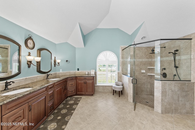 bathroom featuring tile patterned floors, lofted ceiling, a shower with door, and vanity