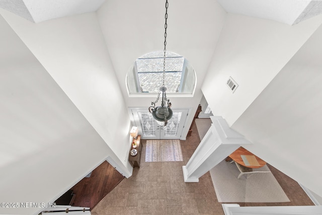 foyer entrance featuring a towering ceiling