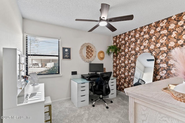 office space featuring ceiling fan, light colored carpet, and a textured ceiling