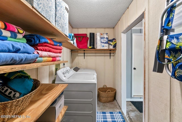 clothes washing area featuring independent washer and dryer and a textured ceiling