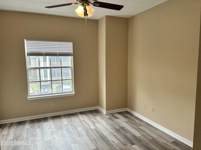 spare room featuring ceiling fan and light hardwood / wood-style floors