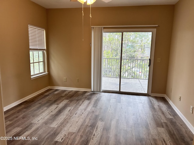 unfurnished room featuring ceiling fan and dark wood-type flooring