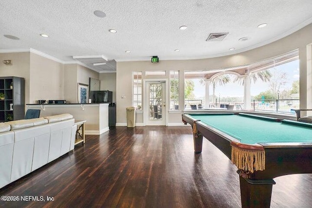 rec room with crown molding, dark wood-type flooring, a textured ceiling, and pool table