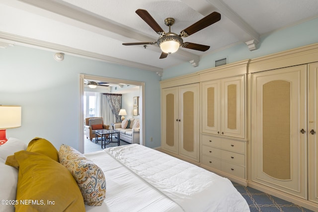 bedroom featuring beamed ceiling, a closet, and ceiling fan