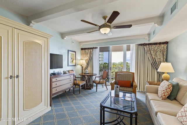 living room featuring beam ceiling, a textured ceiling, and ceiling fan