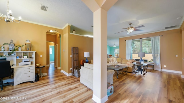 living room with ceiling fan with notable chandelier, crown molding, and light wood-type flooring