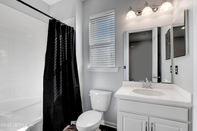 full bathroom with vanity, shower / tub combo, and toilet