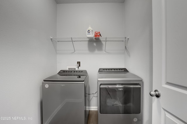 washroom with washer and clothes dryer and hardwood / wood-style floors