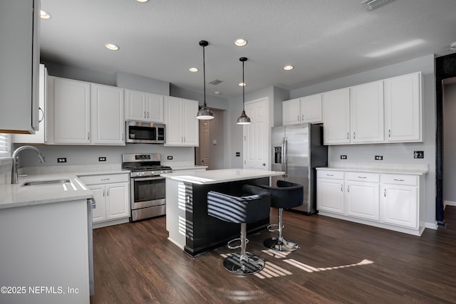 kitchen with sink, white cabinets, and appliances with stainless steel finishes