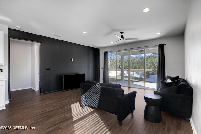 living room featuring dark hardwood / wood-style floors and ceiling fan