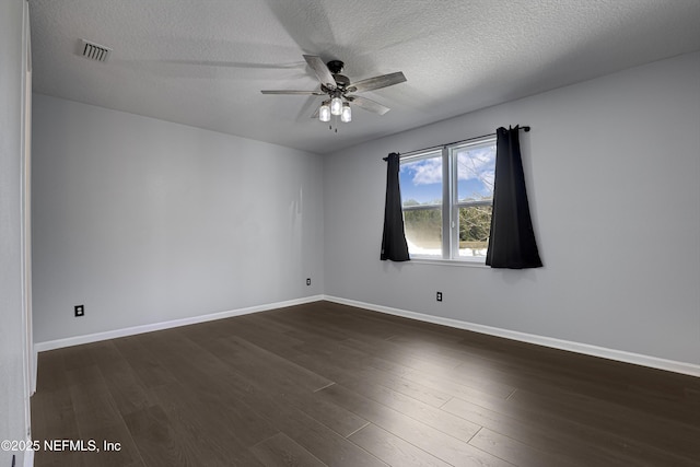 unfurnished room featuring dark hardwood / wood-style flooring, a textured ceiling, and ceiling fan