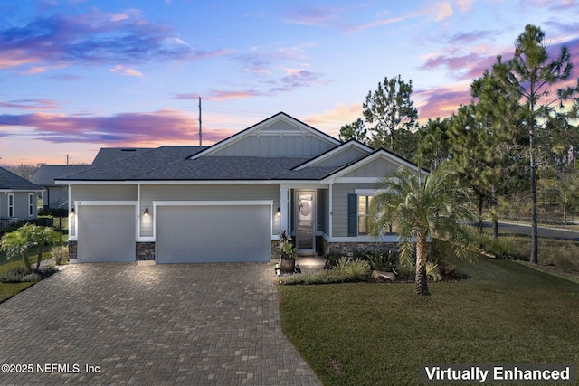 view of front of house featuring a garage and a yard