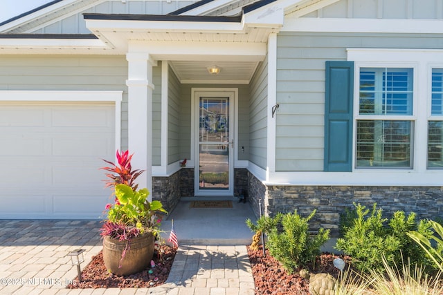 view of exterior entry with a garage