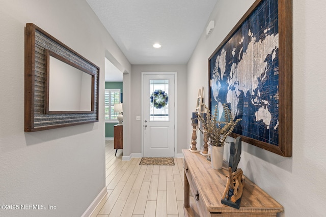 foyer entrance with wood-type flooring and a textured ceiling