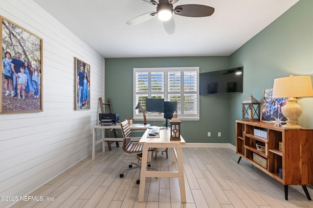 office featuring light hardwood / wood-style floors and ceiling fan