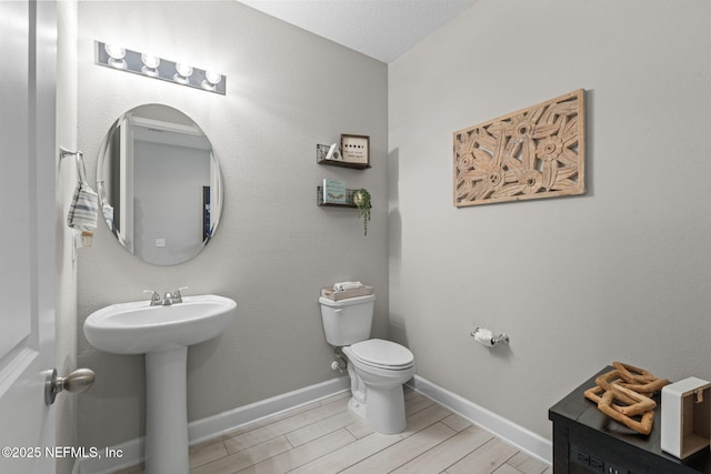 bathroom featuring toilet and sink