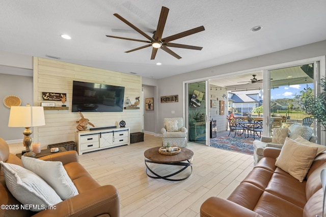 living room with light wood-type flooring and a textured ceiling