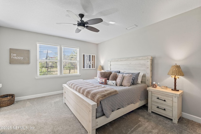 bedroom with a textured ceiling, light colored carpet, and ceiling fan