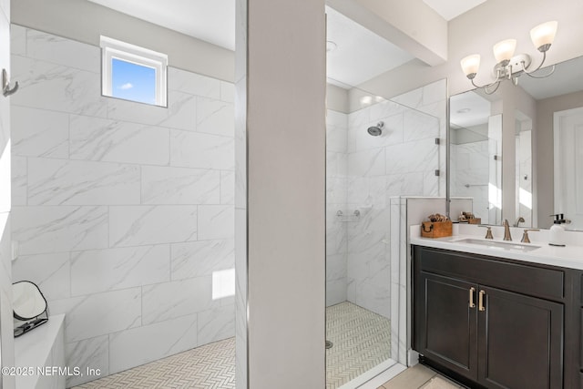 bathroom featuring tile patterned flooring, vanity, and tiled shower