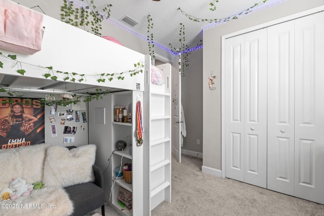 carpeted bedroom with a closet