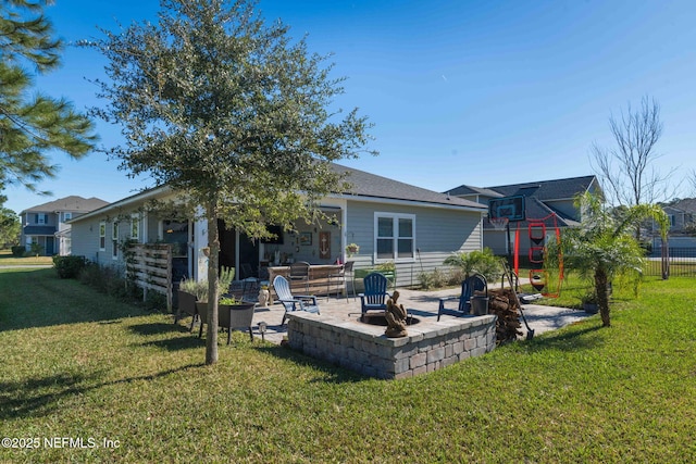 back of house featuring a patio area and a lawn