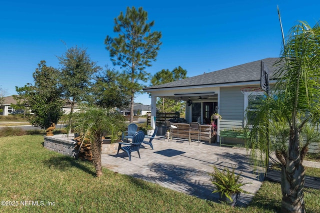 view of yard featuring a patio and ceiling fan