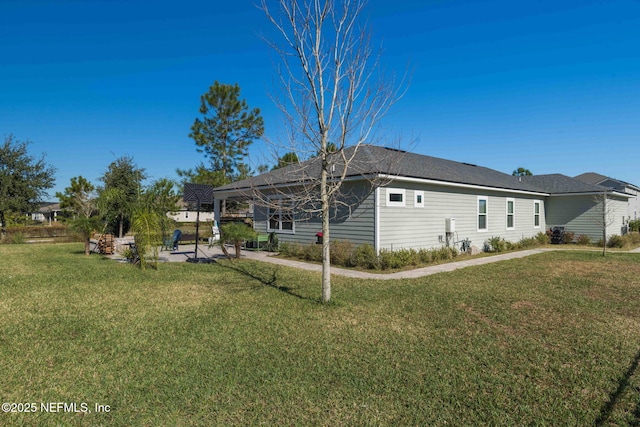 rear view of house with a lanai and a yard