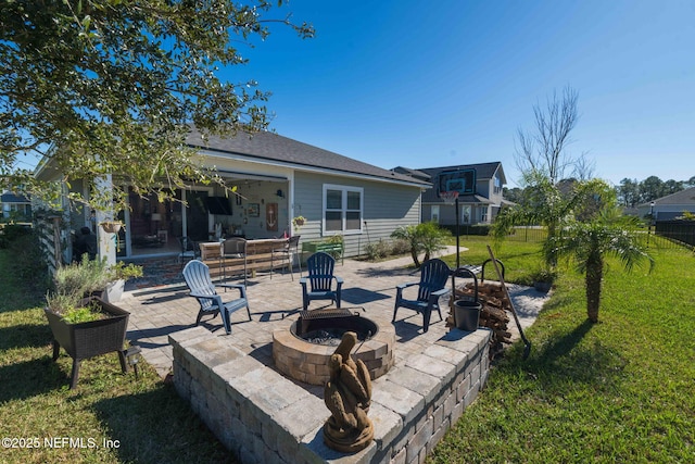 back of house with a patio area, a yard, and an outdoor living space with a fire pit