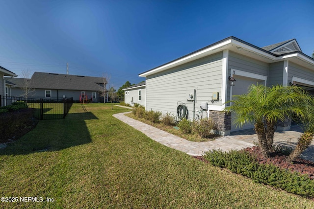 view of side of property with a lawn and a garage