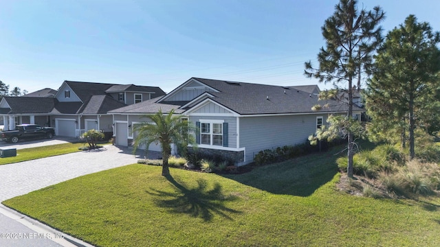 single story home featuring a front lawn and a garage