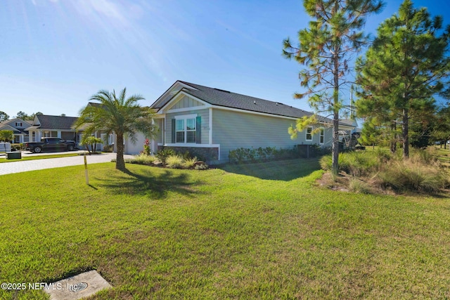 view of side of home with a lawn