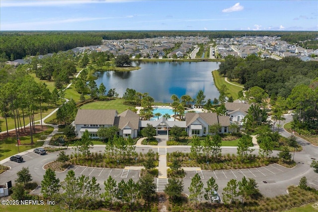 birds eye view of property with a water view